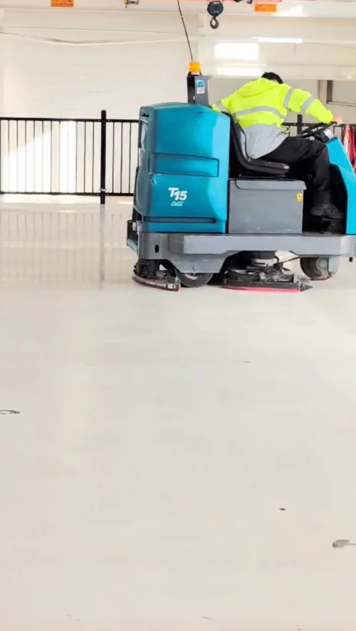 Close view of the commercial floor-cleaning machine and operator